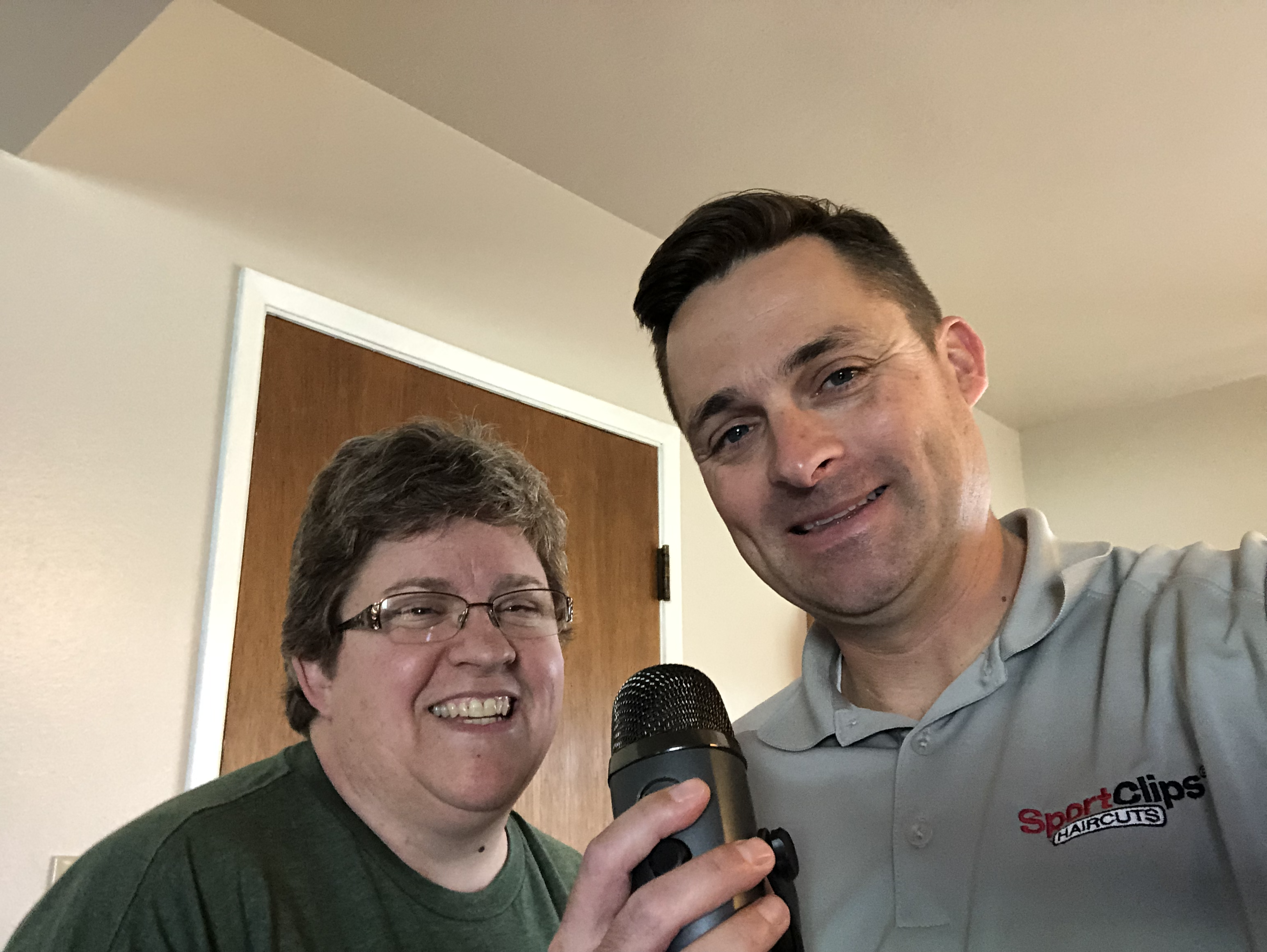 Chad Jordan and Kelly McGloughlin holding a microphone